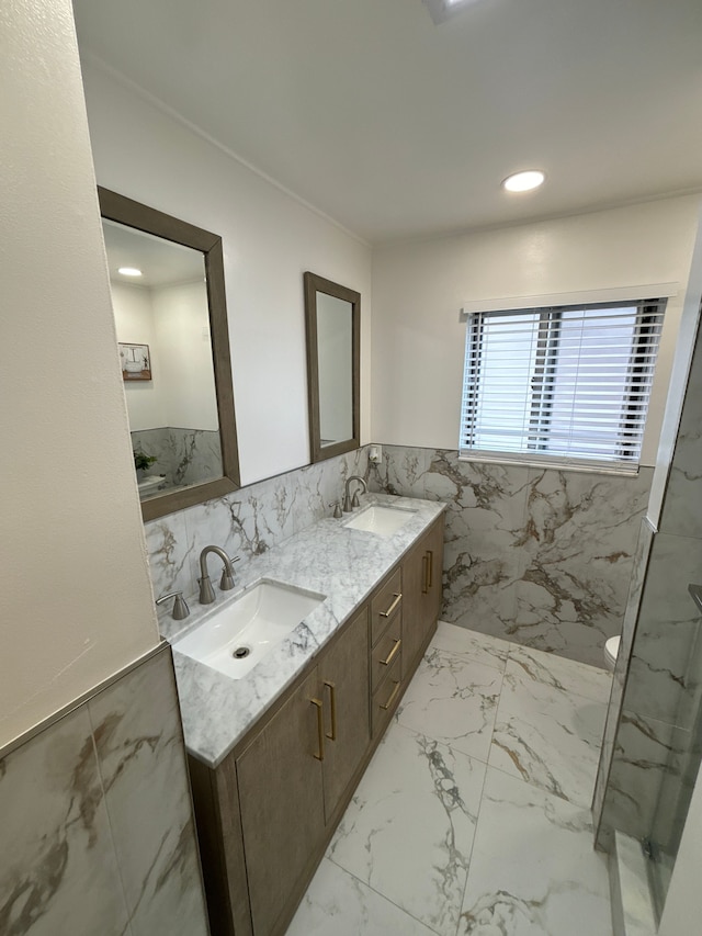 bathroom featuring tiled shower, vanity, and tile walls