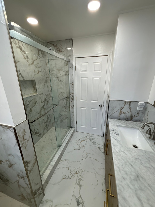 bathroom featuring vanity, an enclosed shower, and tile walls