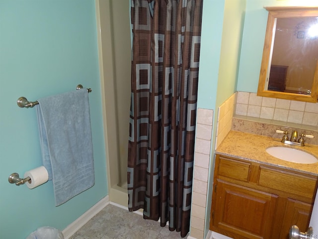 bathroom with decorative backsplash and vanity