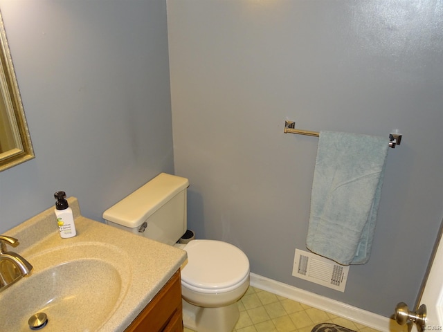 bathroom with tile patterned flooring, vanity, and toilet