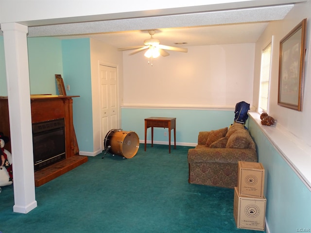 sitting room featuring ceiling fan and dark carpet