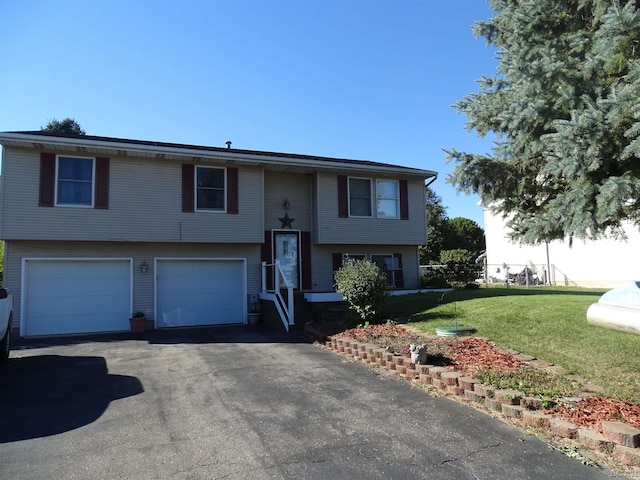 split foyer home with a garage and a front lawn