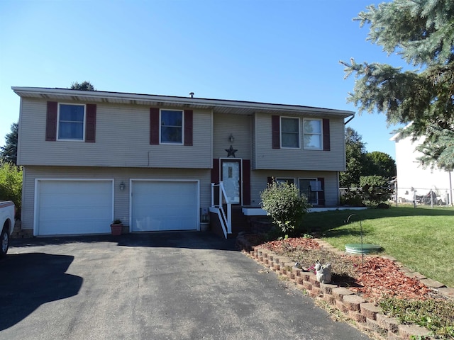 split foyer home featuring a front lawn and a garage