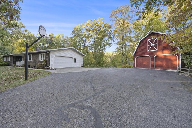 11600 Baker Rd, Greenville, MI 48838 - view of asphalt driveway with a barn