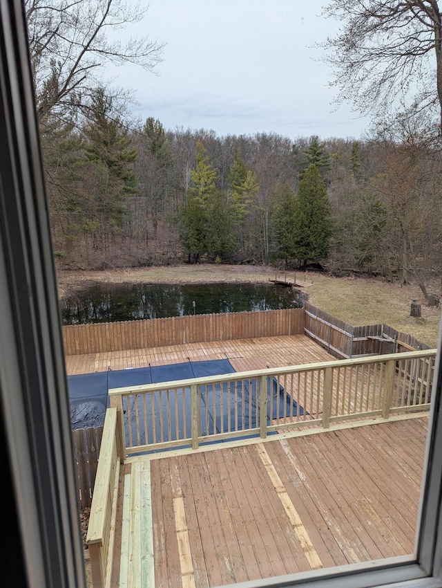 wooden deck featuring a view of trees and a water view