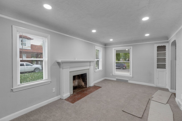 unfurnished living room featuring light carpet, a fireplace, and ornamental molding