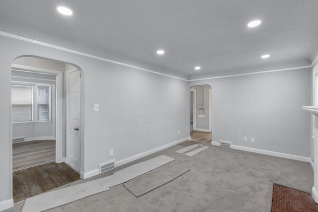 empty room with hardwood / wood-style floors and ornamental molding