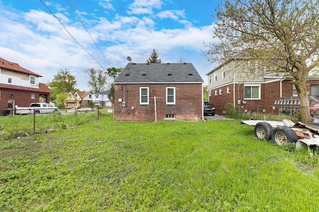 rear view of house featuring a lawn