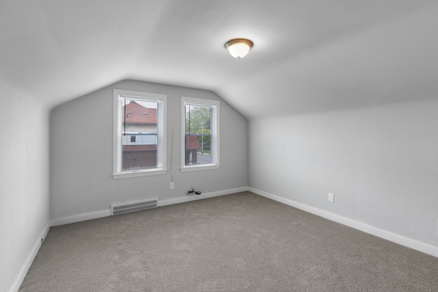 bonus room with carpet flooring and lofted ceiling