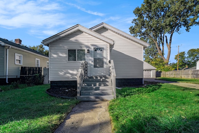 bungalow-style house with a front lawn