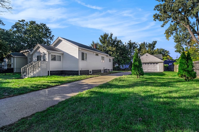 exterior space with an outbuilding, a front yard, and a garage