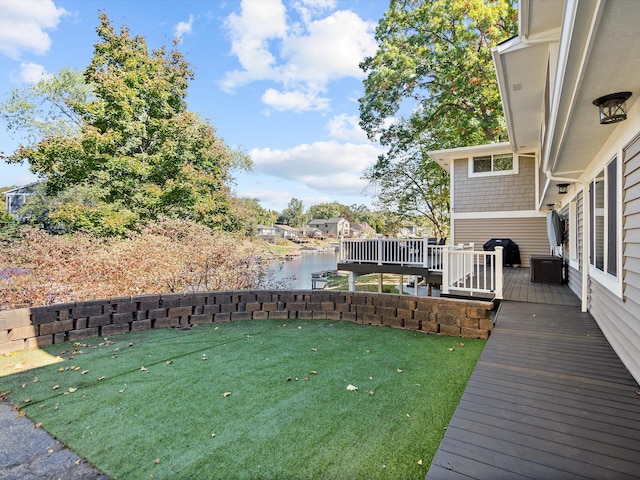 view of yard featuring a deck with water view and central AC