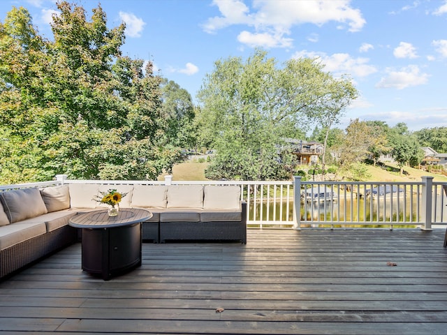 wooden deck featuring a water view and an outdoor hangout area