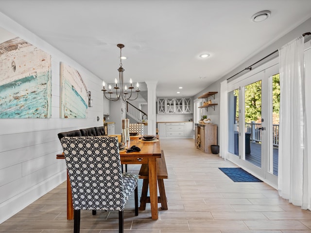 dining space featuring light hardwood / wood-style floors and an inviting chandelier