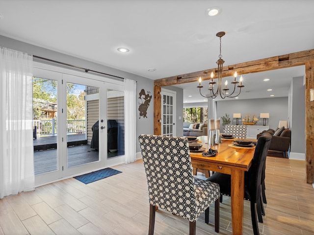 dining area with french doors, light hardwood / wood-style flooring, and a notable chandelier