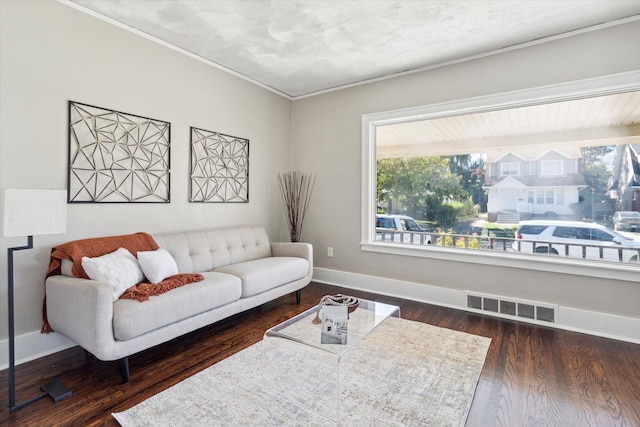 living room with ornamental molding and dark wood-type flooring