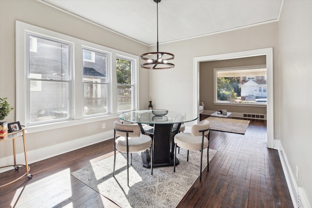 dining room featuring dark hardwood / wood-style floors, a wealth of natural light, and a notable chandelier