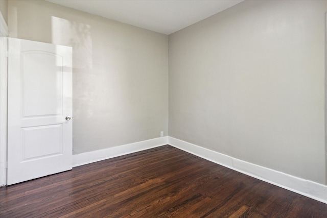 spare room featuring dark hardwood / wood-style floors