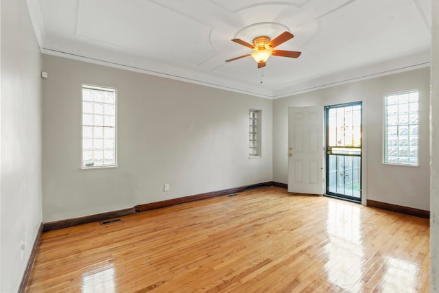 empty room with light hardwood / wood-style flooring and a healthy amount of sunlight