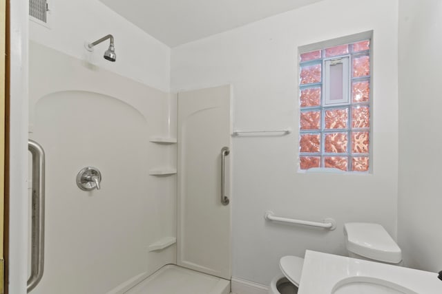 bathroom with walk in shower and toilet