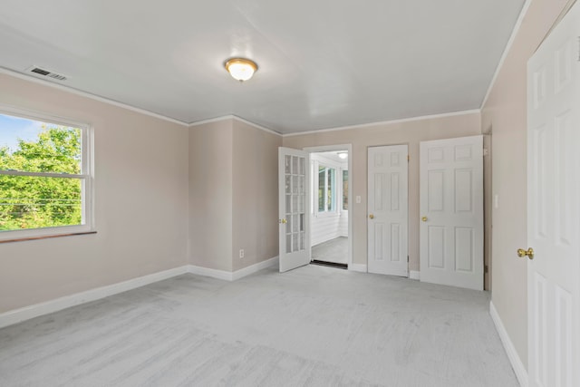 unfurnished bedroom featuring light colored carpet and crown molding