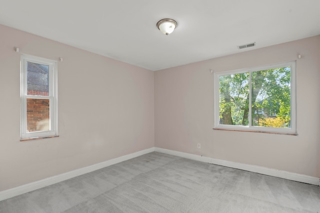 spare room with light colored carpet