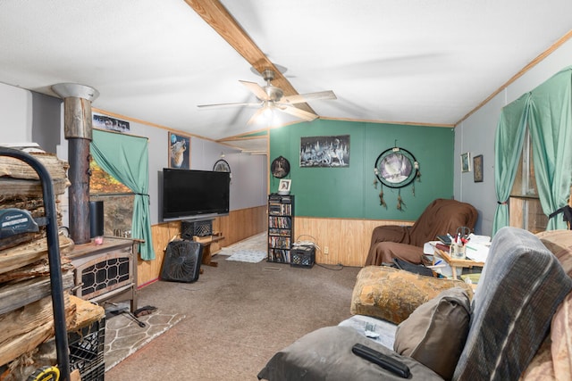 living room with carpet flooring, ceiling fan, wooden walls, crown molding, and lofted ceiling