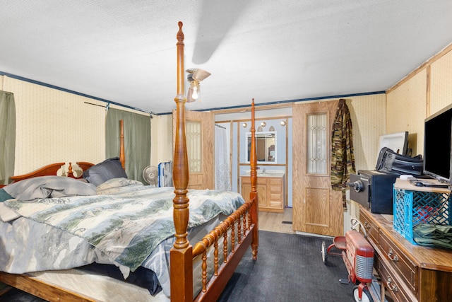 bedroom with a textured ceiling, dark hardwood / wood-style floors, and crown molding