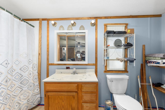 bathroom with a shower with curtain, vanity, and toilet