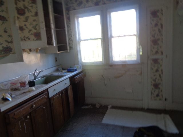 kitchen featuring light tile patterned floors and sink