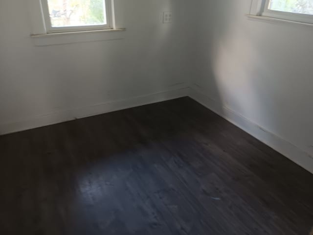 empty room with dark hardwood / wood-style floors