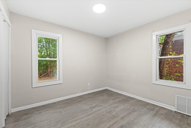 spare room with a healthy amount of sunlight and light hardwood / wood-style floors