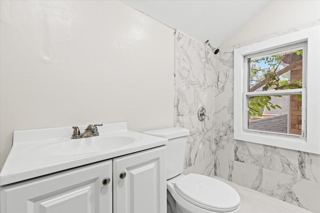 bathroom with vanity, toilet, walk in shower, and vaulted ceiling