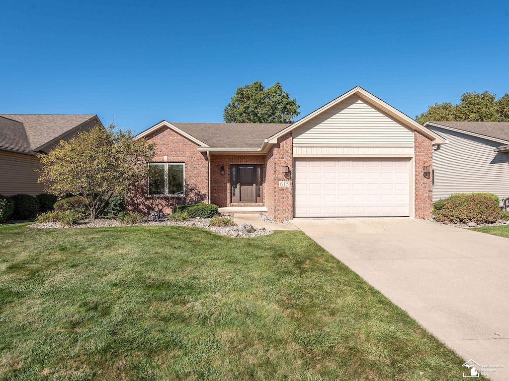 ranch-style home featuring a front yard and a garage