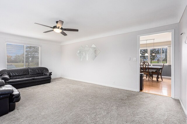 3735 S Portsmouth Rd, Bridgeport, MI 48722 - living area featuring carpet floors, baseboards, and a ceiling fan