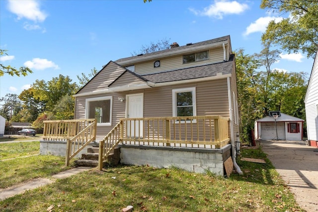 view of front of property with an outbuilding, a front yard, and a garage