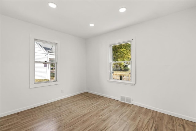 unfurnished room with a healthy amount of sunlight and light wood-type flooring