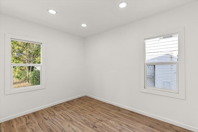 spare room with hardwood / wood-style floors