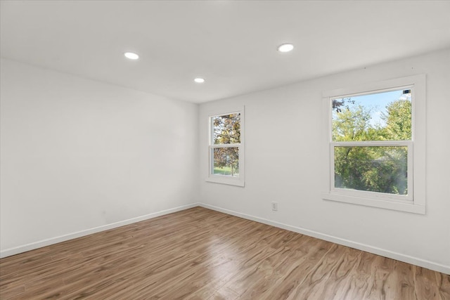 unfurnished room with hardwood / wood-style flooring