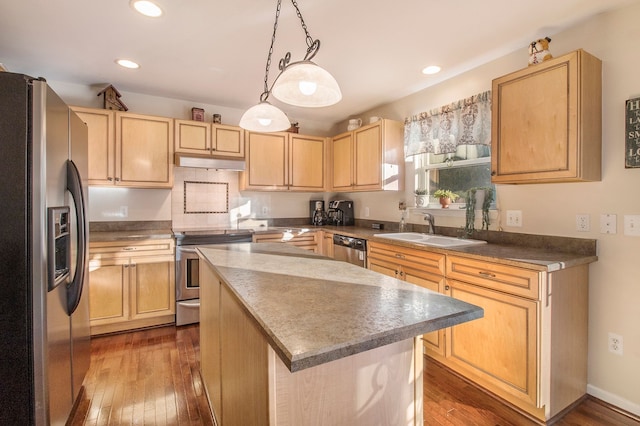 kitchen with appliances with stainless steel finishes, dark hardwood / wood-style flooring, sink, light brown cabinets, and a center island