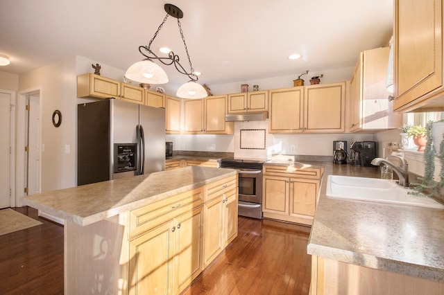 kitchen featuring light brown cabinets, stainless steel appliances, a kitchen island, and sink