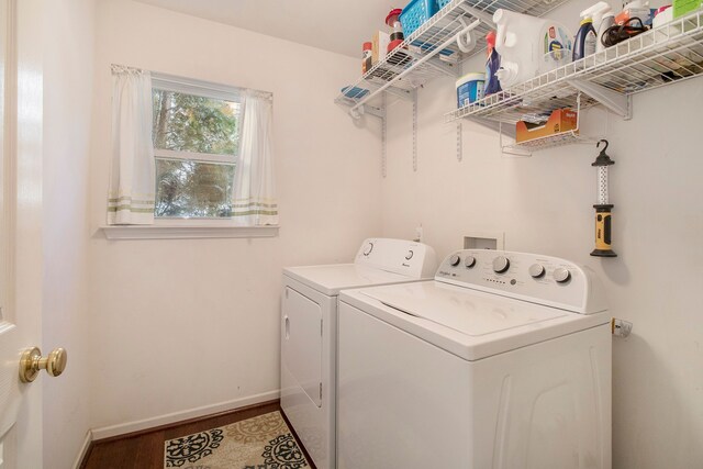 clothes washing area featuring hardwood / wood-style flooring and washing machine and clothes dryer