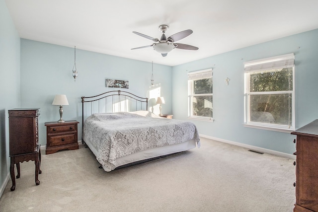 bedroom featuring ceiling fan and light carpet