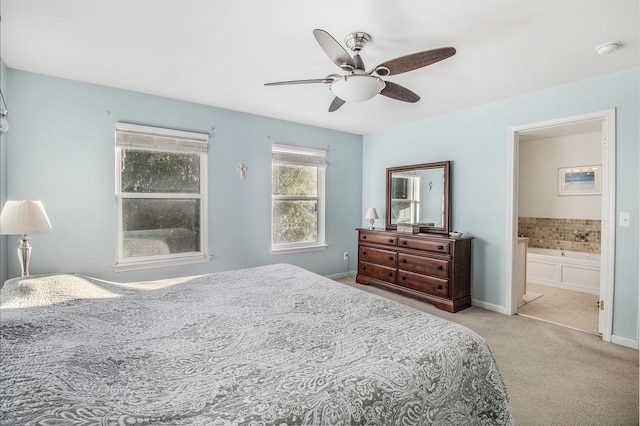 carpeted bedroom featuring ensuite bath and ceiling fan