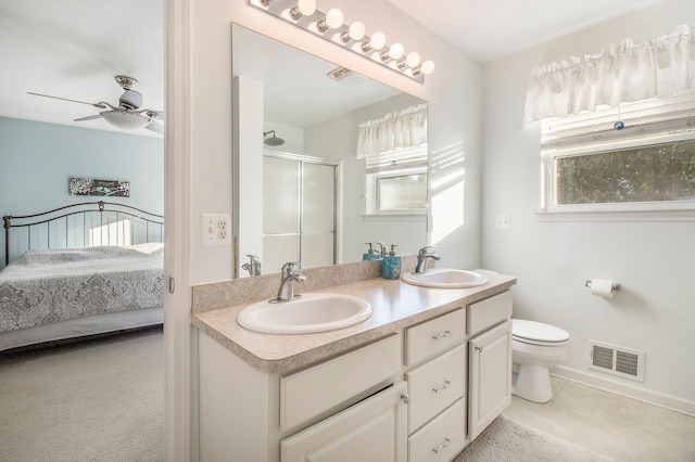 bathroom with vanity, tile patterned flooring, ceiling fan, toilet, and an enclosed shower