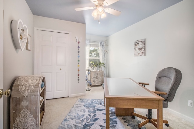 home office with ceiling fan and light carpet