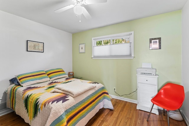 bedroom with ceiling fan and hardwood / wood-style flooring