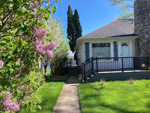 doorway to property featuring a lawn