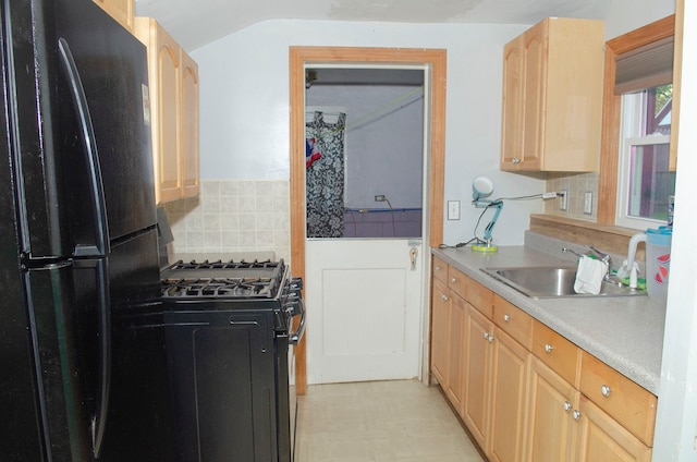 kitchen featuring backsplash, light brown cabinetry, sink, and black appliances