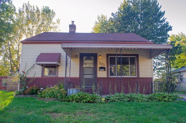 bungalow-style home with a porch and a front yard